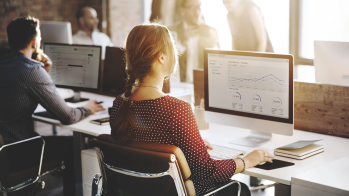 woman with ecommerce stats on monitor