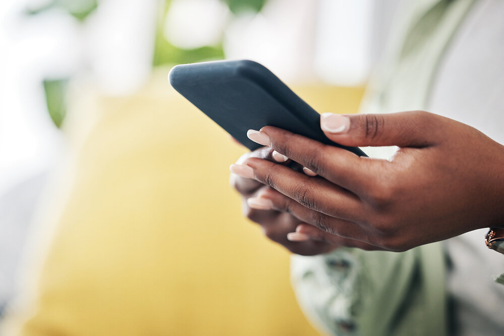 Woman's hands using phone