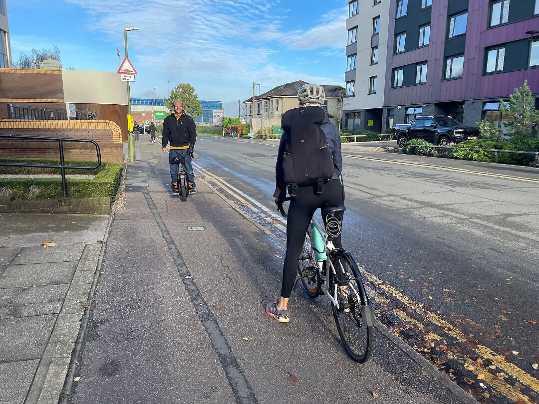 Envisage staff riding bike and escooter