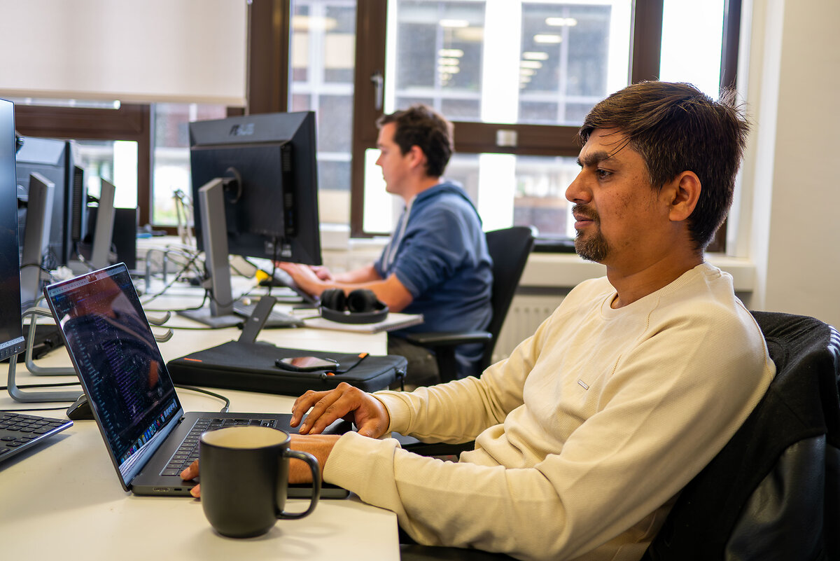 Men working with laptops