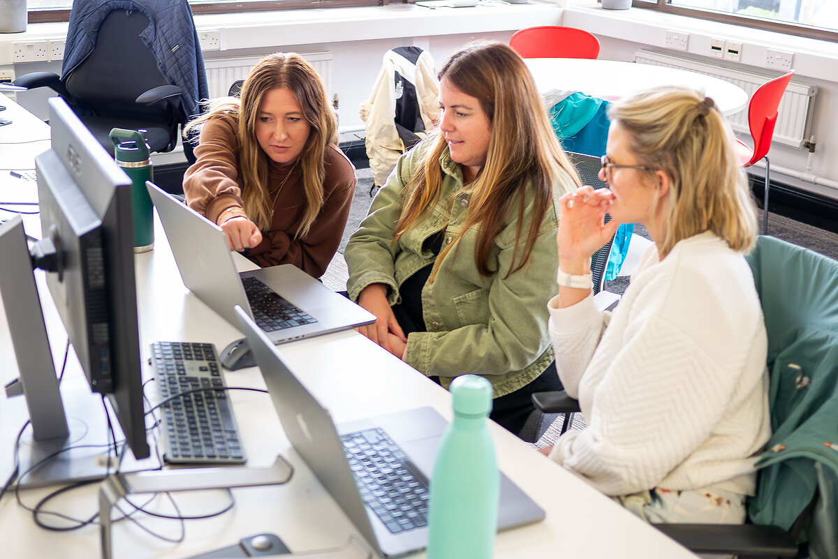 3 woman working with a computer