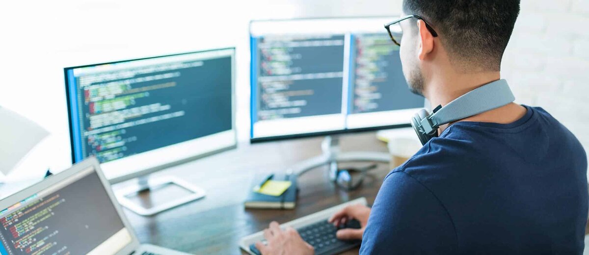 Coder Working On 4 Screens
