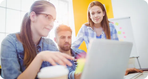 Colleagues around a laptop