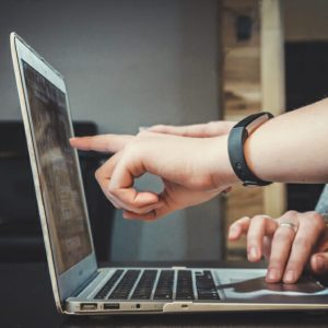 People pointing at laptop