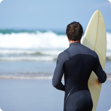 Surfer In Wetsuit Looking At Waves