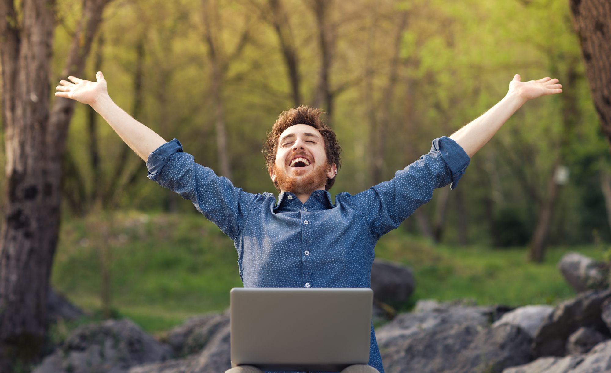 Happy Man In Woods With Laptop