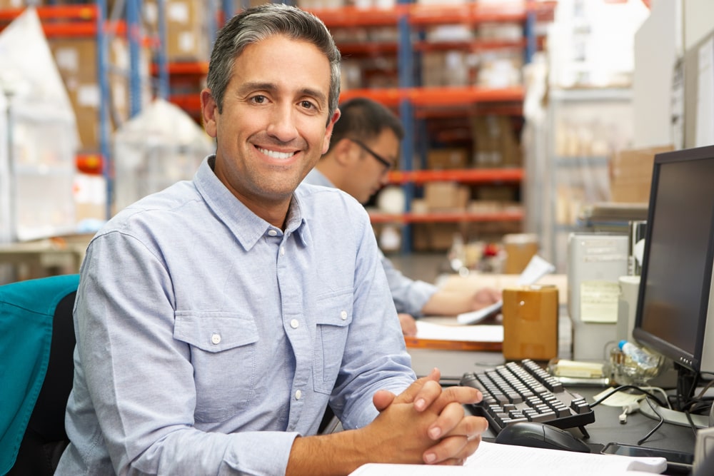 Man Smiling At Desk